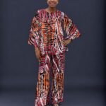 White orange and black adire cape like top and trouser with slit sleeves